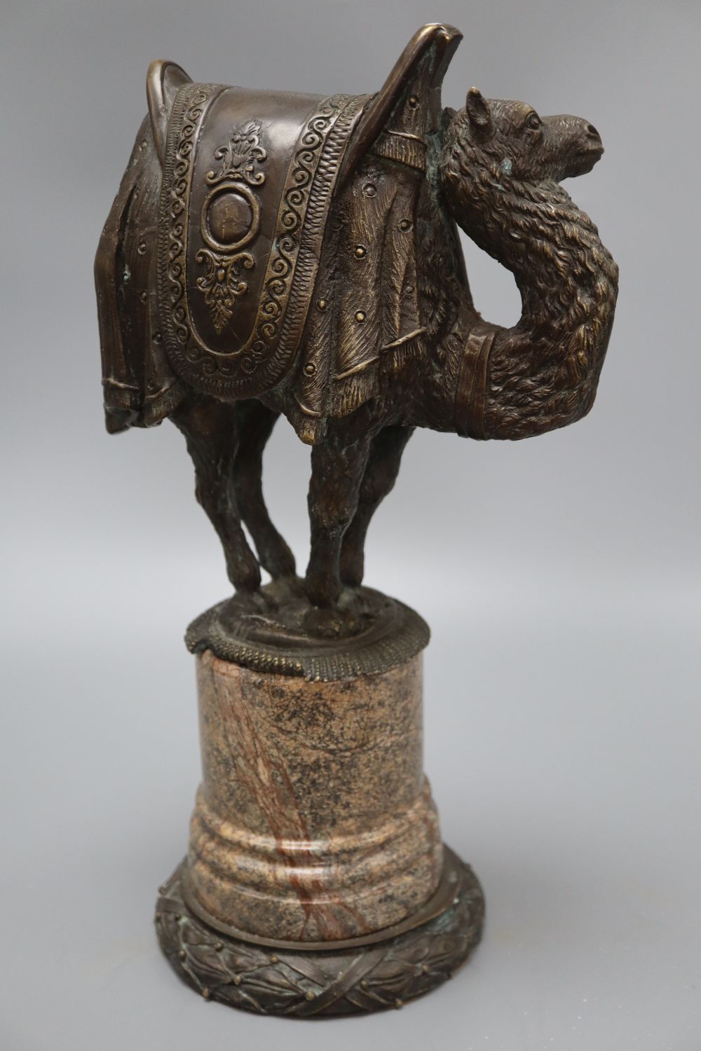 A bronze model of a camel, on a marble base, height 38cm